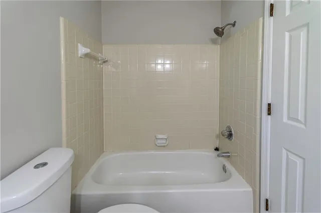 a bathroom with a bathtub and toilet