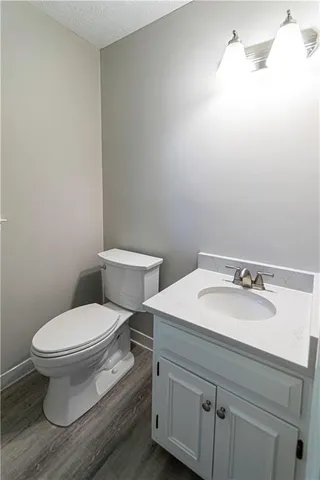 a white toilet sitting next to a bathroom sink