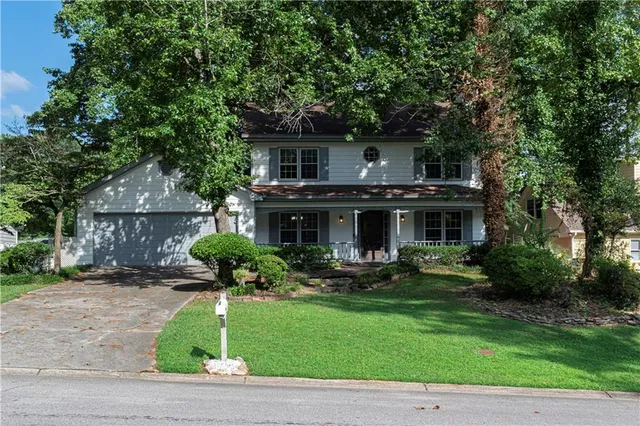 a view of a house with a yard and sitting area