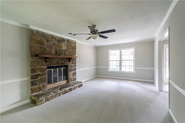 a living room with fireplace furniture and a window