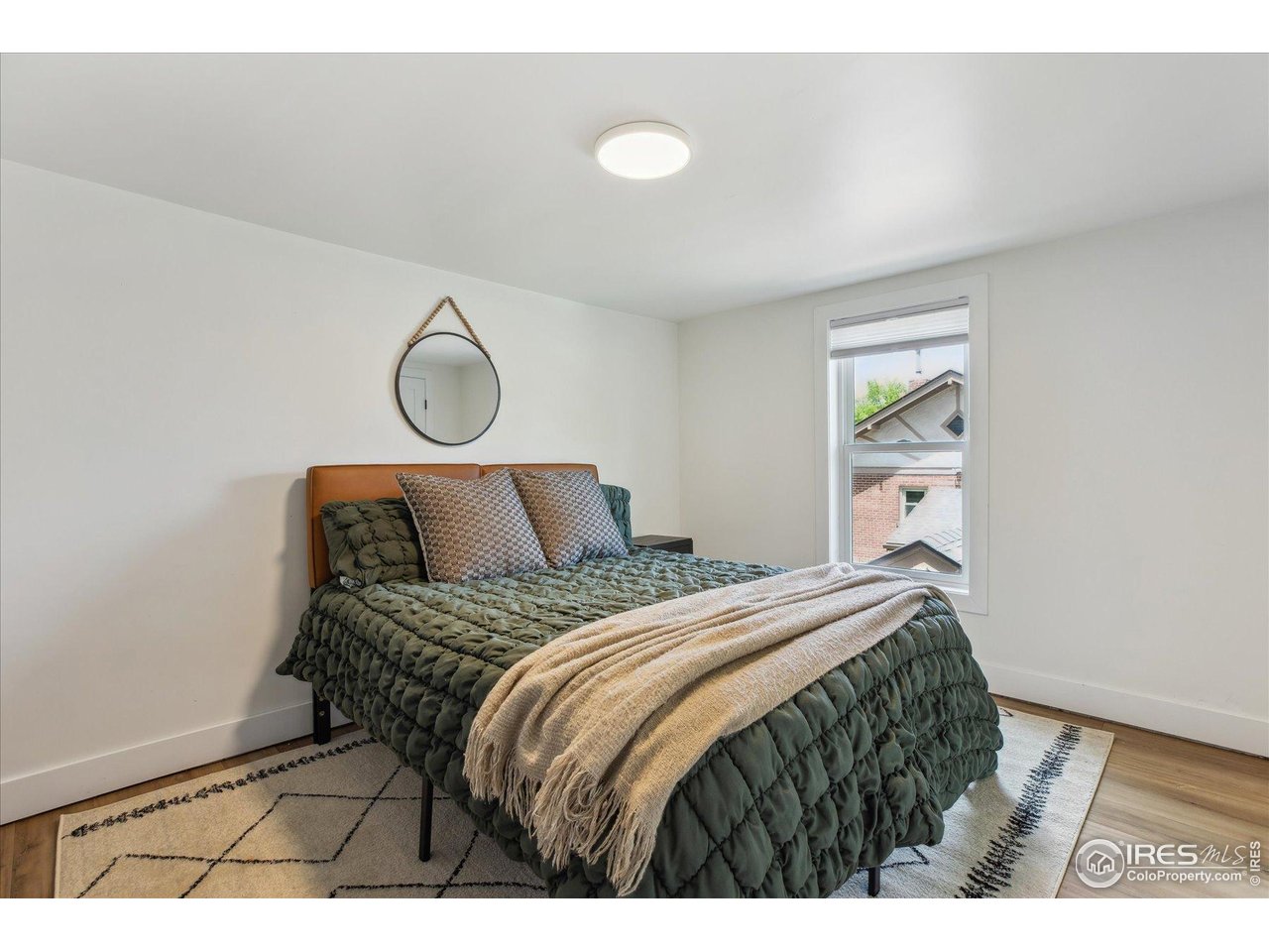 2844 Quitman Street Denver, CO 80212 - Photo 24 of 41 a bedroom with a bed and wooden floor