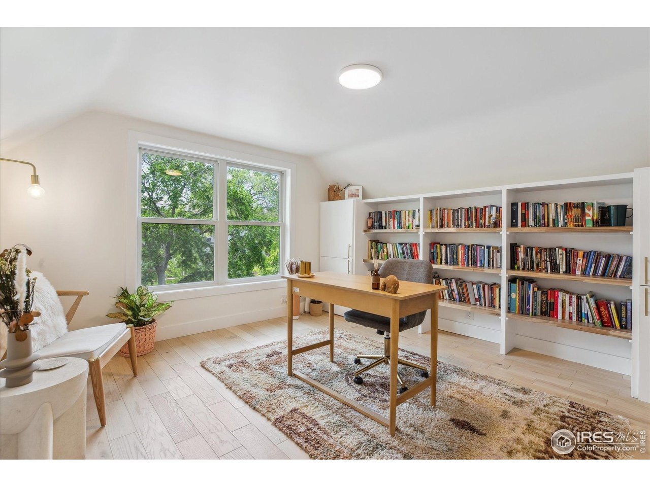 2844 Quitman Street Denver, CO 80212 - Photo 25 of 41 a living room with furniture and a book shelf