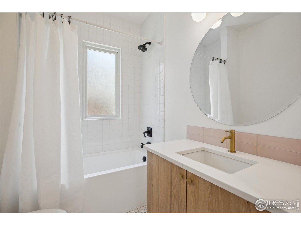 2844 Quitman Street Denver, CO 80212 - Photo 28 of 41 a bathroom with a sink and a mirror