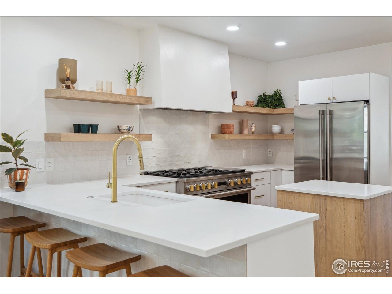 2844 Quitman Street Denver, CO 80212 - Photo 3 of 41 a kitchen with kitchen island a sink a stove and refrigerator
