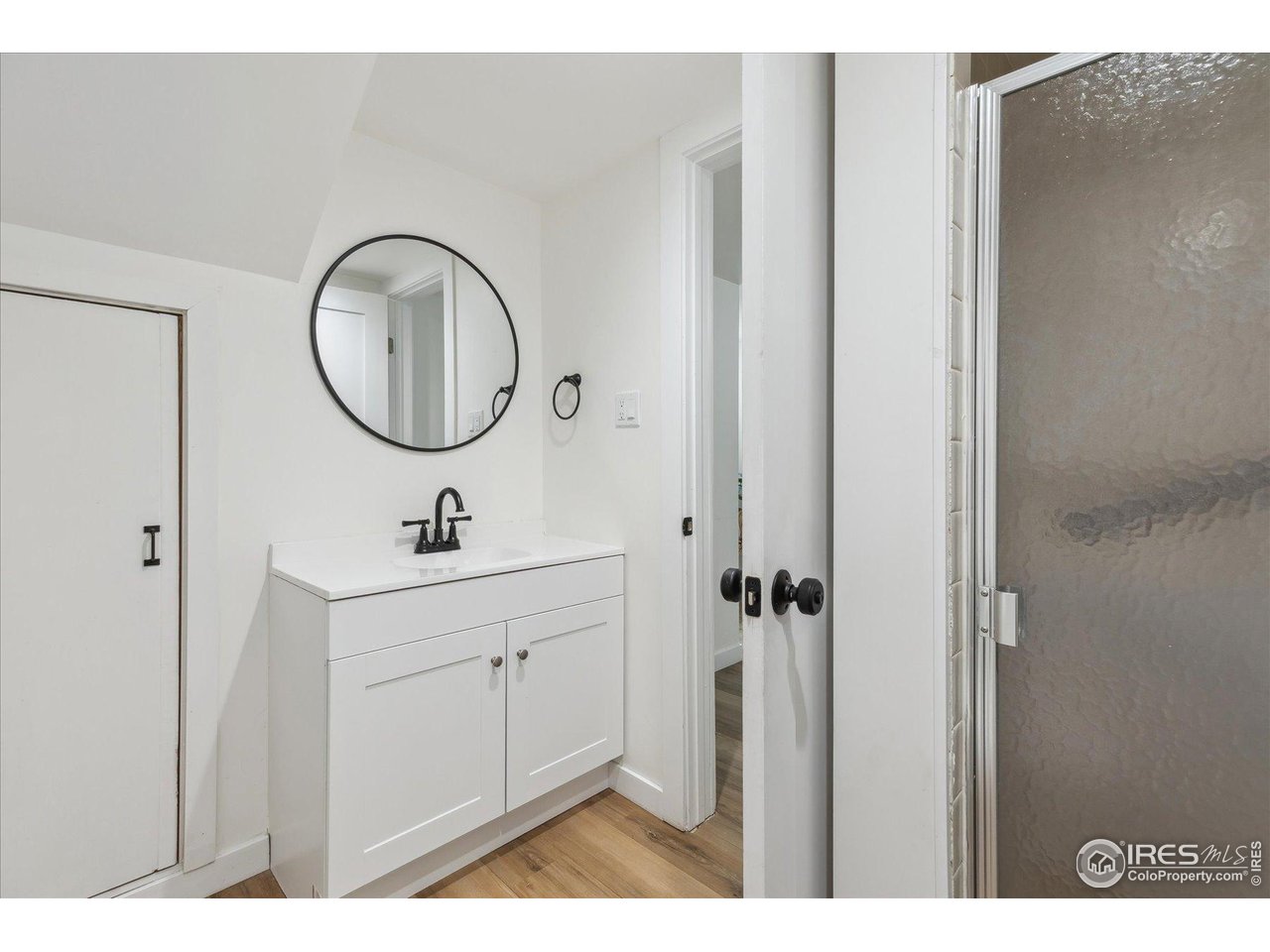 2844 Quitman Street Denver, CO 80212 - Photo 32 of 41 a bathroom with a sink a mirror and a shower