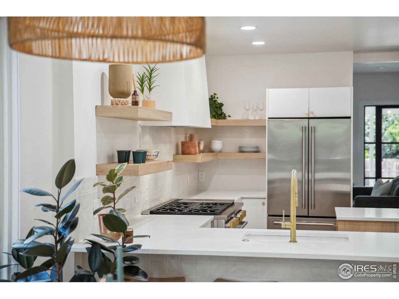 2844 Quitman Street Denver, CO 80212 - Photo 6 of 41 a kitchen with kitchen island a stove a refrigerator and a sink