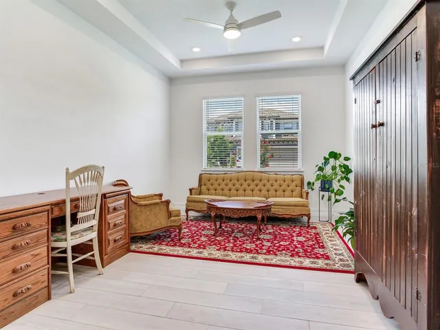 a living room with furniture and a view of kitchen