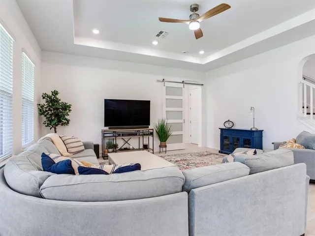 a kitchen with a dining table chairs stainless steel appliances and cabinets