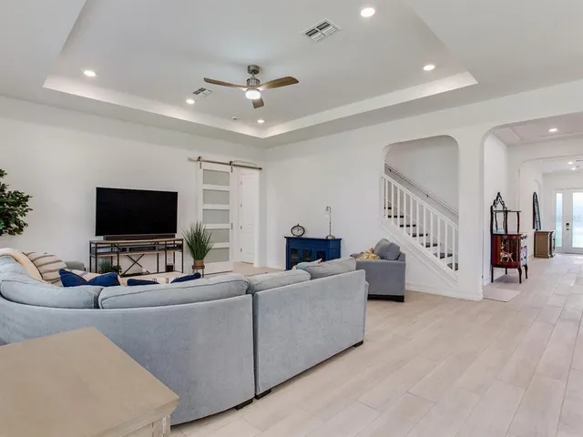 a kitchen with stainless steel appliances kitchen island granite countertop a kitchen island a stove a table and chairs