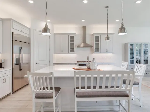 a large bed sitting in a bedroom next to a window