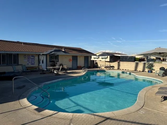 a view of a patio with table and chairs under an umbrella