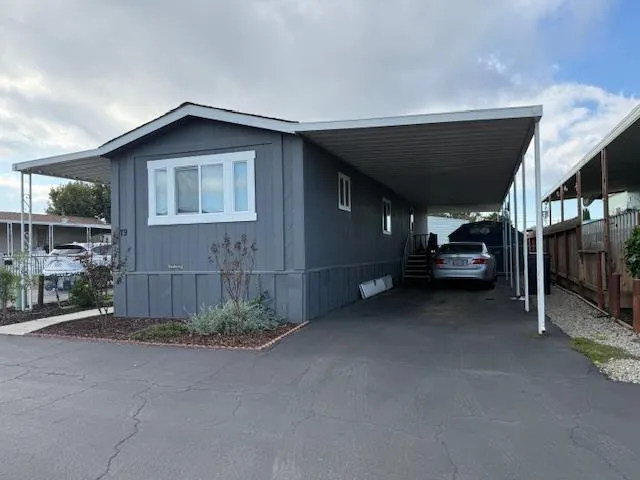 a kitchen with a dining table chairs and white appliances
