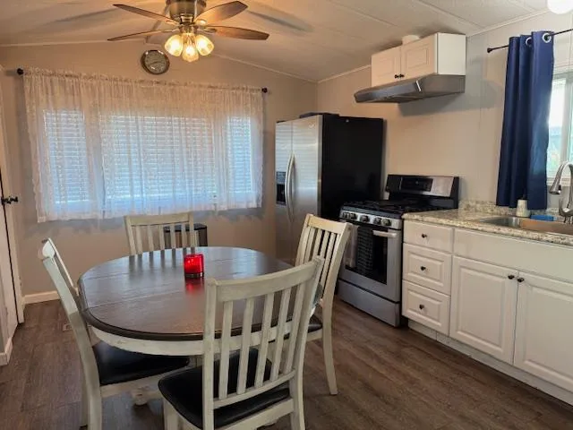 a view of a dining room with furniture a chandelier and wooden floor
