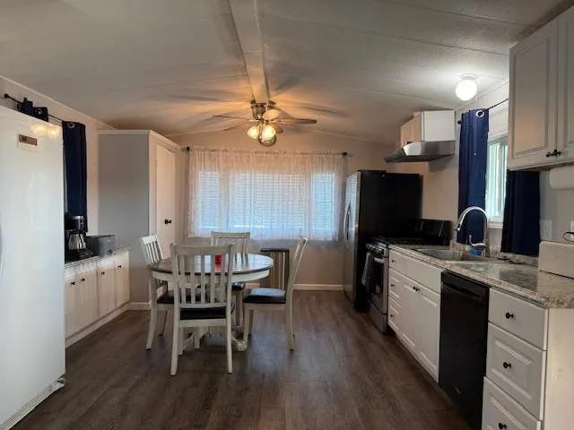 a view of kitchen with furniture and wooden floor