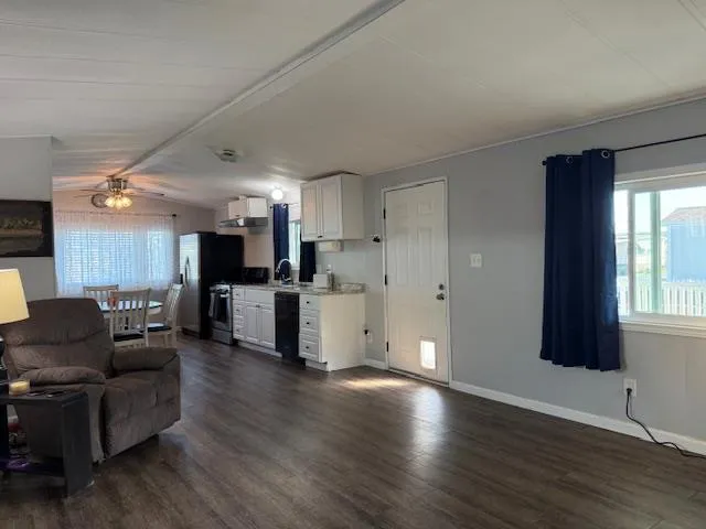 a living room with furniture and kitchen view