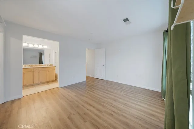 a bathroom with a granite countertop sink a mirror and a shower