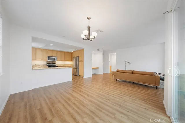 a view of kitchen and dining room with wooden floor