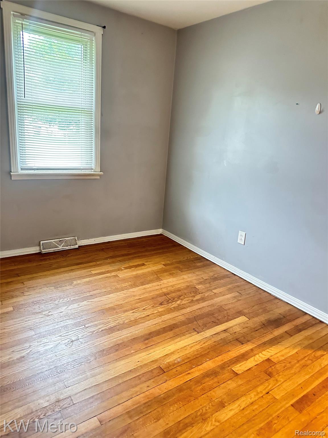 78 Orchard Street River Rouge, MI 48218 - Photo 6 of 8 Hardwood flooring, painted walls, window with blinds, and white trim