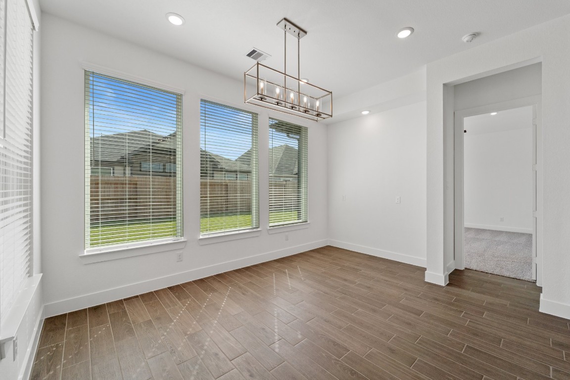 310 Blue River Trail Rosenberg, TX 77471 - Photo 18 of 47 a view of an empty room with wooden floor and a window