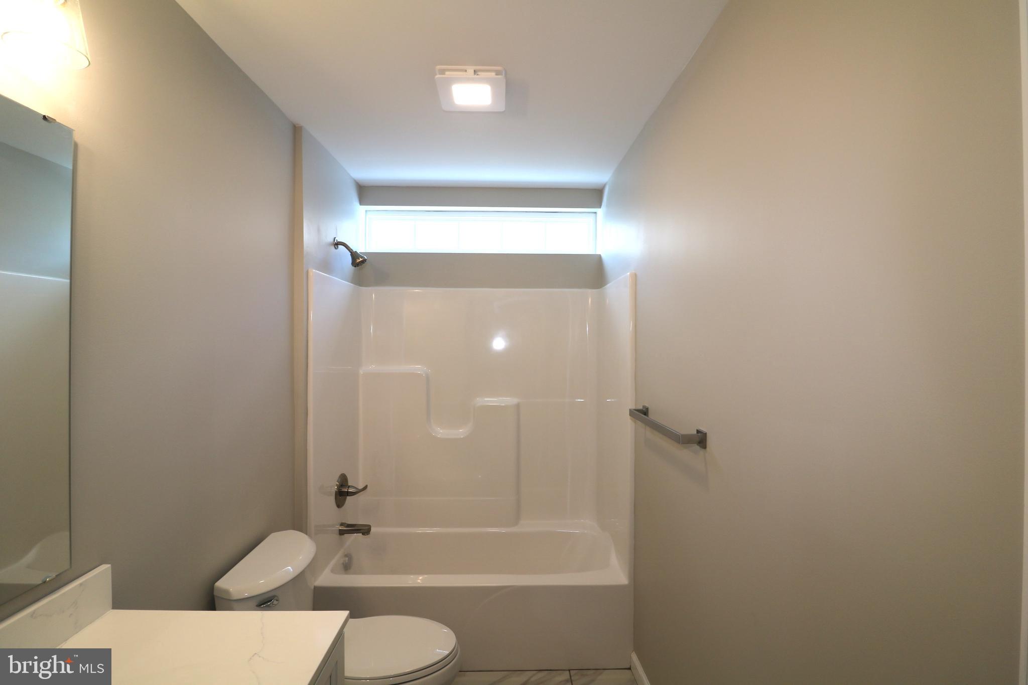 38 Rosalie's Way Temple, PA 19560 - Photo 11 of 15 a bathroom with a granite countertop sink toilet and shower