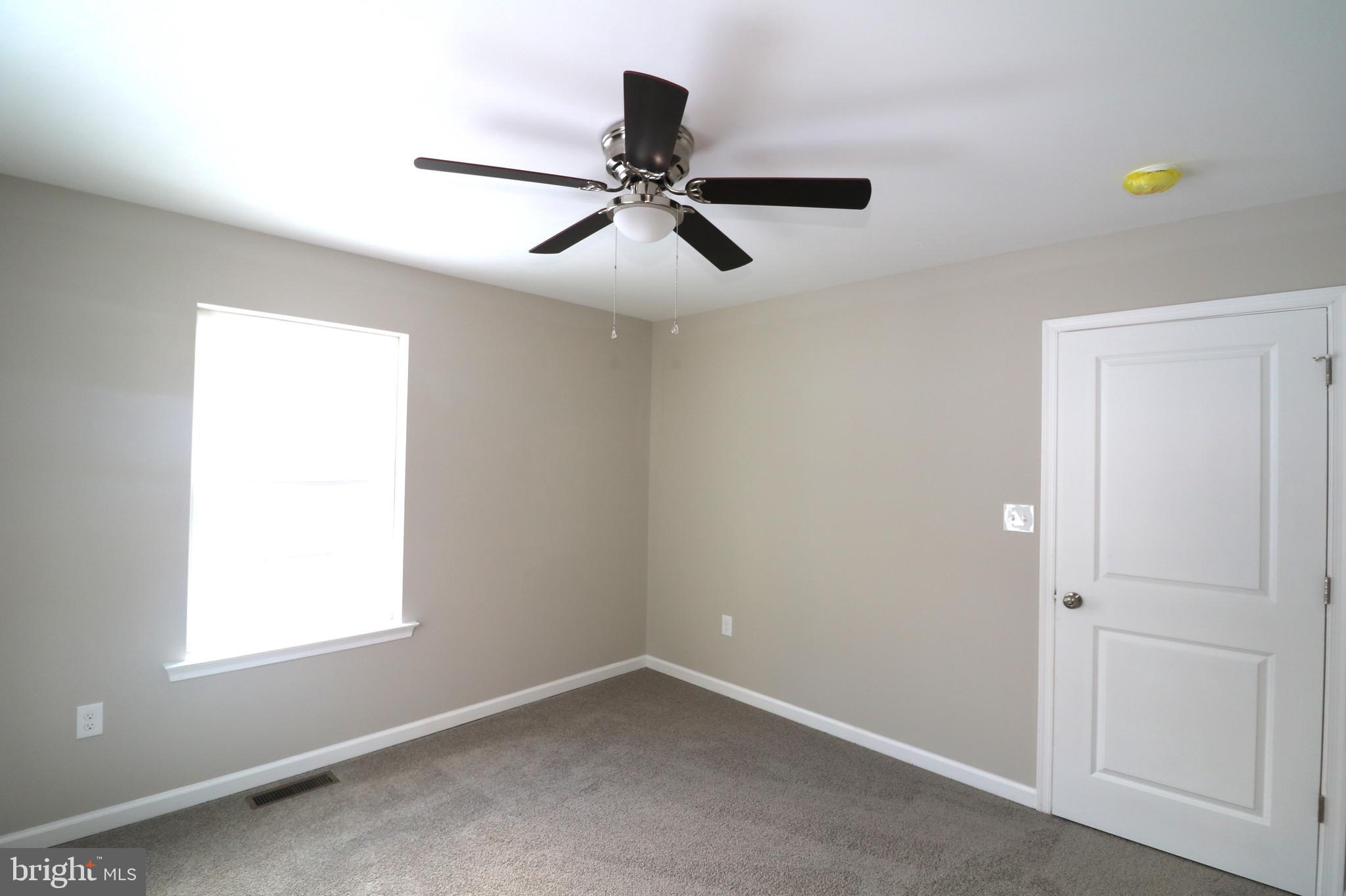 38 Rosalie's Way Temple, PA 19560 - Photo 13 of 15 an empty room with a window and a ceiling fan