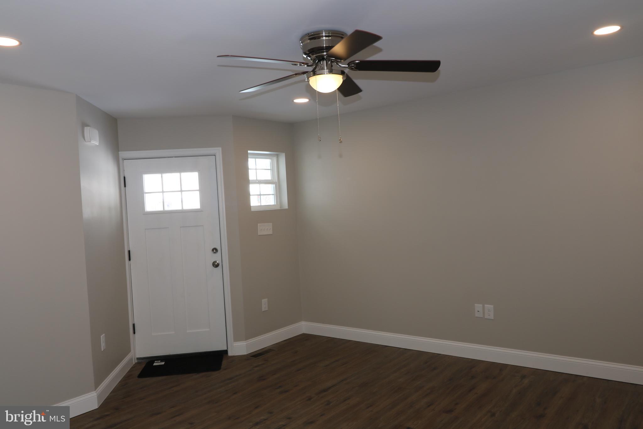 38 Rosalie's Way Temple, PA 19560 - Photo 2 of 15 an empty room with wooden floor and windows