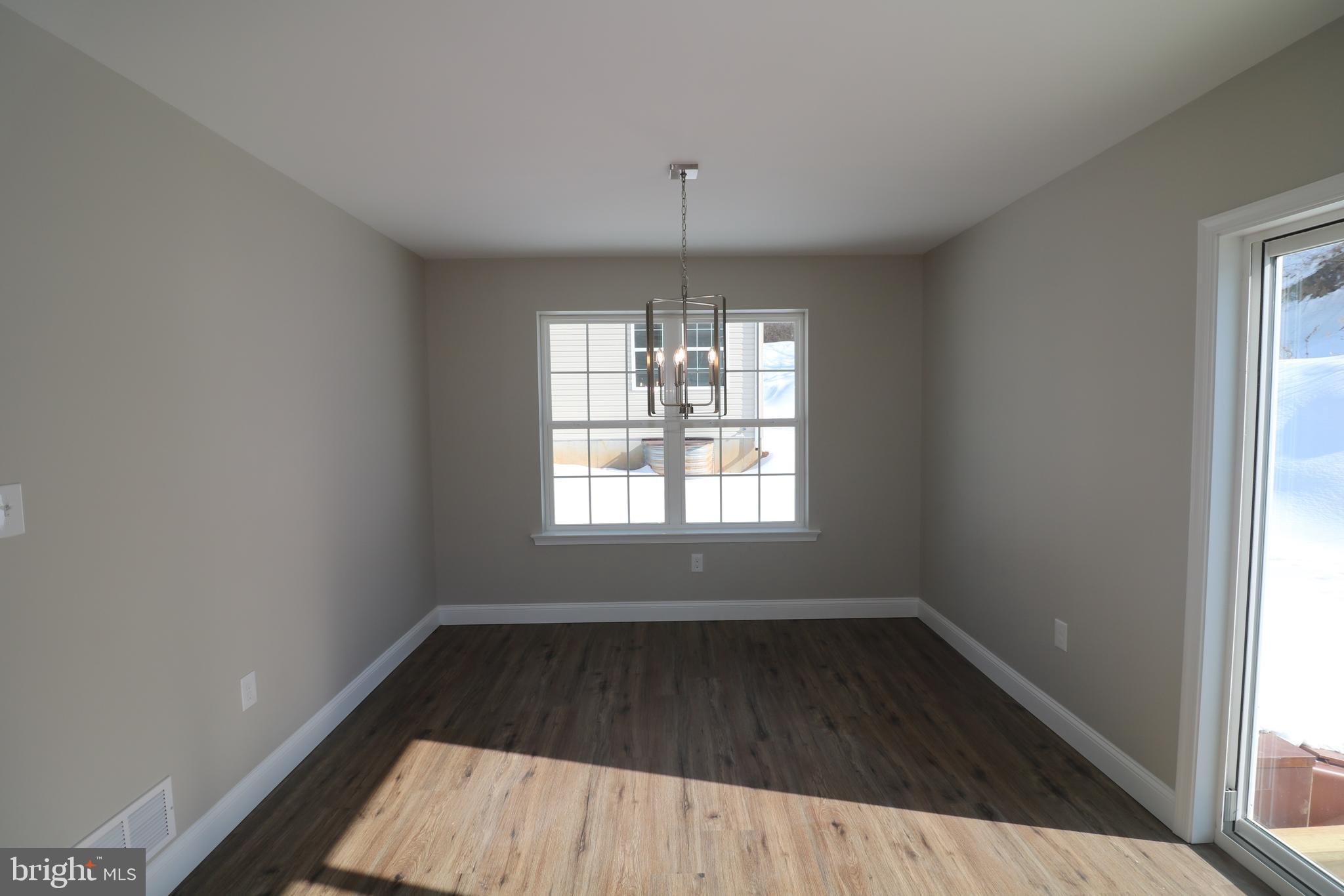 38 Rosalie's Way Temple, PA 19560 - Photo 6 of 15 an empty room with wooden floor and windows