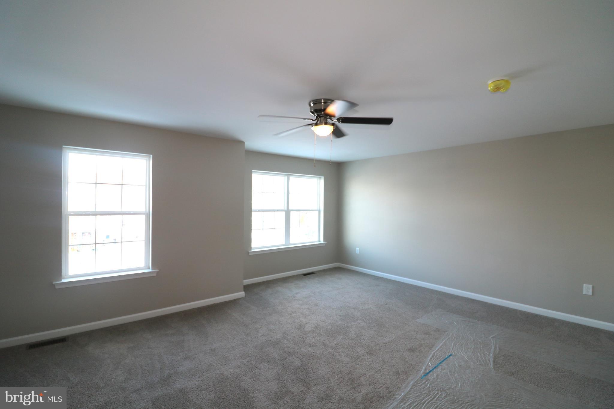 38 Rosalie's Way Temple, PA 19560 - Photo 7 of 15 an empty room with windows and chandelier fan