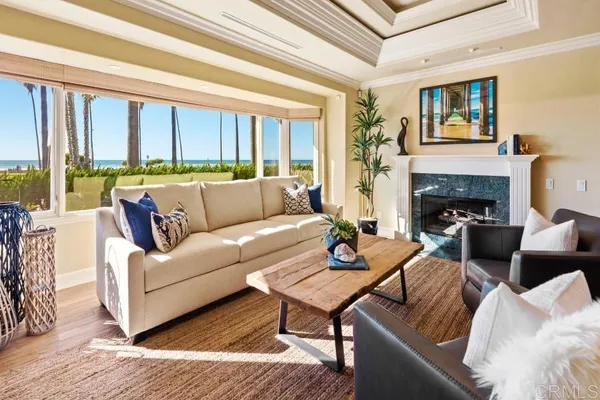 a living room with furniture wooden floor and a large window