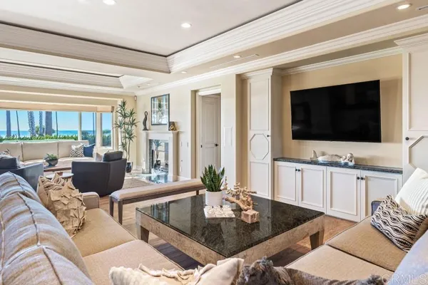 a living room with furniture two window and a flat screen tv