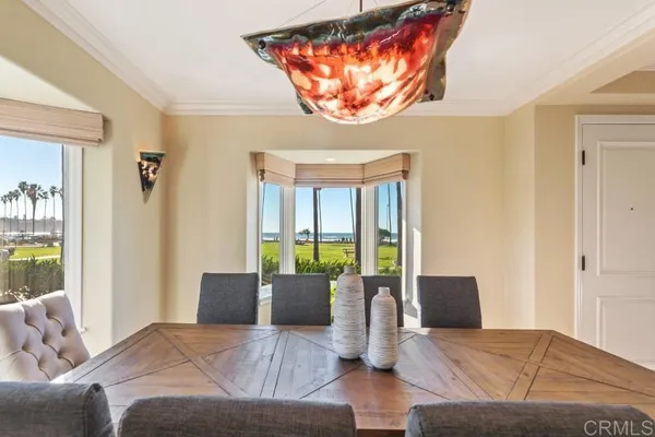 a bedroom with a large bed and windows