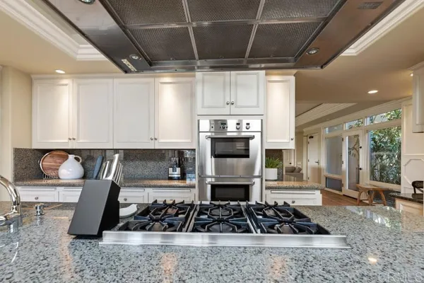 a bathroom with a granite countertop sink a mirror a bathtub and shower