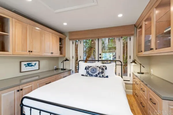 a bedroom with a bed and a mirror