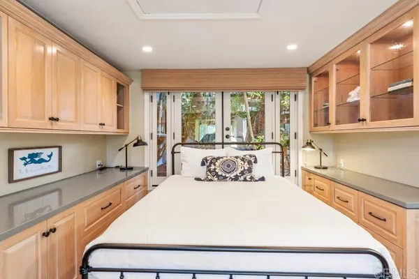 a bathroom with a granite countertop double sink and a mirror