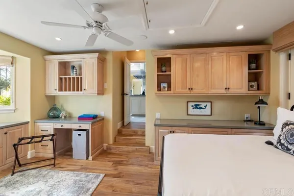 a bathroom with a granite countertop sink a toilet and a mirror