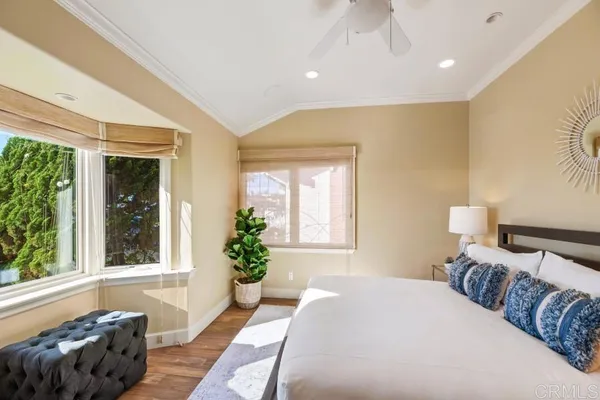 a bedroom with a bed and glass windows