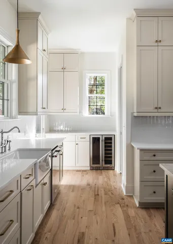 a kitchen with stainless steel appliances granite countertop a sink and dishwasher with white cabinets