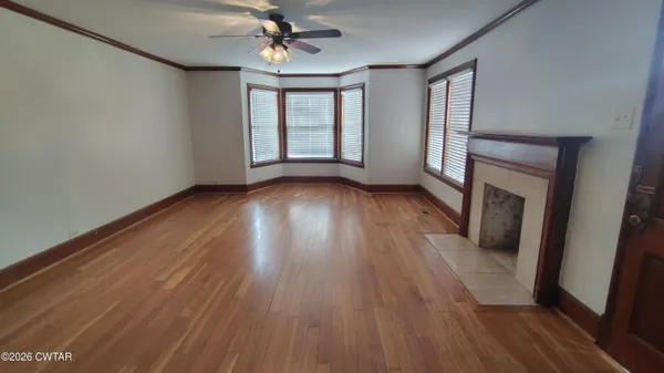 wooden floor in an empty room with a window