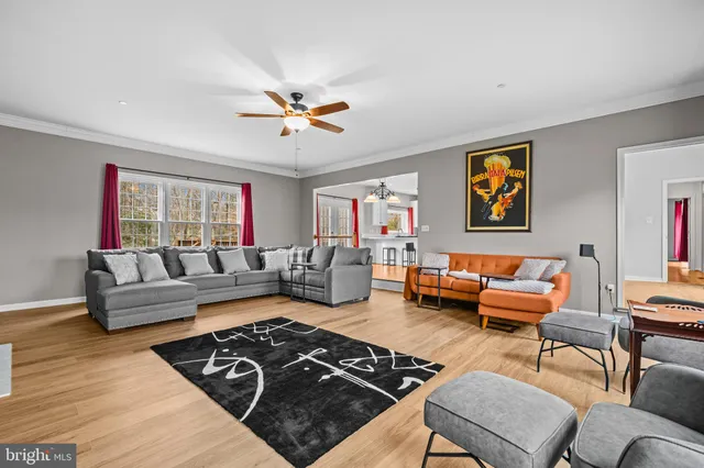 a open kitchen with stainless steel appliances granite countertop a stove refrigerator and cabinets with wooden floor