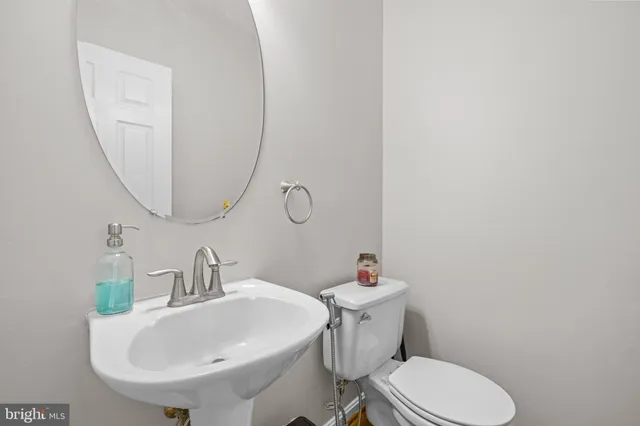 a living room with furniture and a lamp