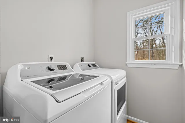 a bedroom with two beds and a chandelier