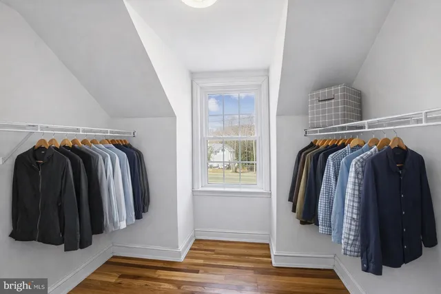 an aerial view of a house with a yard and wooden fence