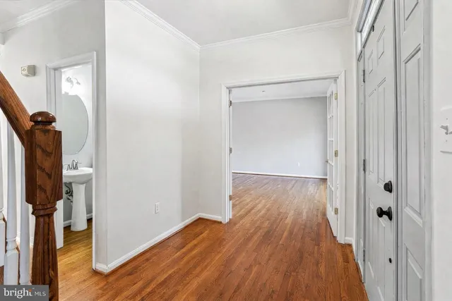 a dining room with furniture a chandelier and wooden floor