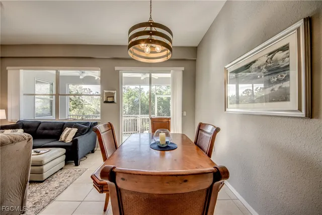 a view of a dining room with furniture and chandelier