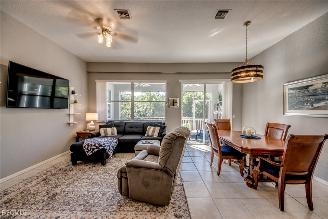 3181 Matecumbe Key Road, Unit 11 Punta Gorda, FL 33955 - Photo 19 of 50 a living room with furniture a chandelier and a flat screen tv