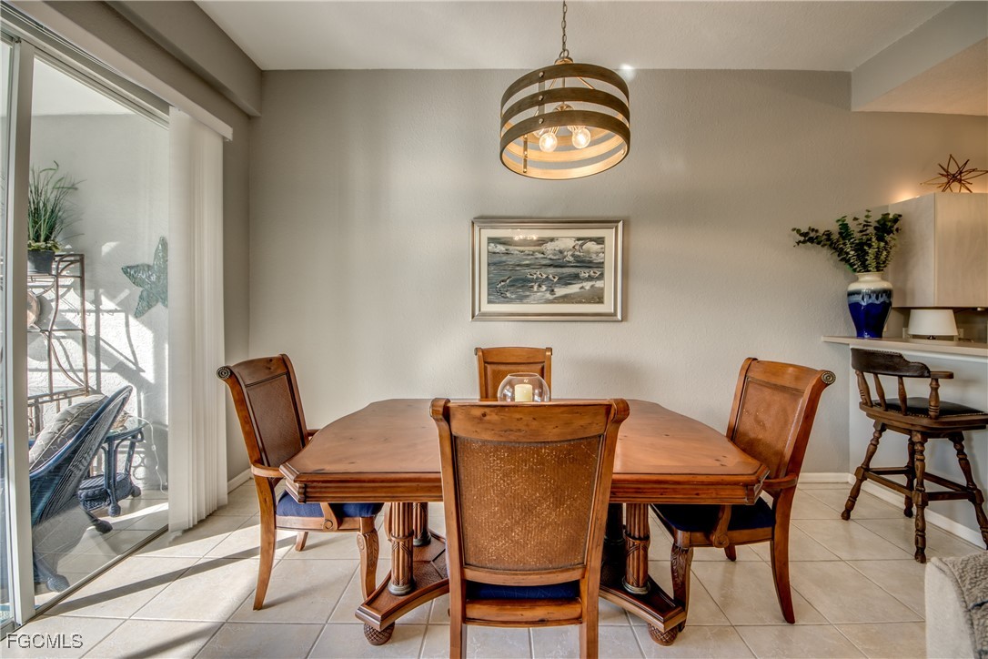 3181 Matecumbe Key Road, Unit 11 Punta Gorda, FL 33955 - Photo 22 of 50 a view of a dining room with furniture and chandelier