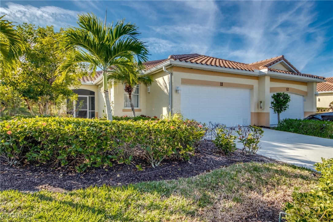 3181 Matecumbe Key Road, Unit 11 Punta Gorda, FL 33955 - Photo 3 of 50 a front view of a house with a garden