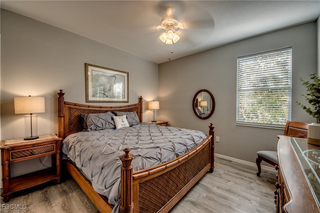 3181 Matecumbe Key Road, Unit 11 Punta Gorda, FL 33955 - Photo 31 of 50 a bedroom with a bed and a chandelier