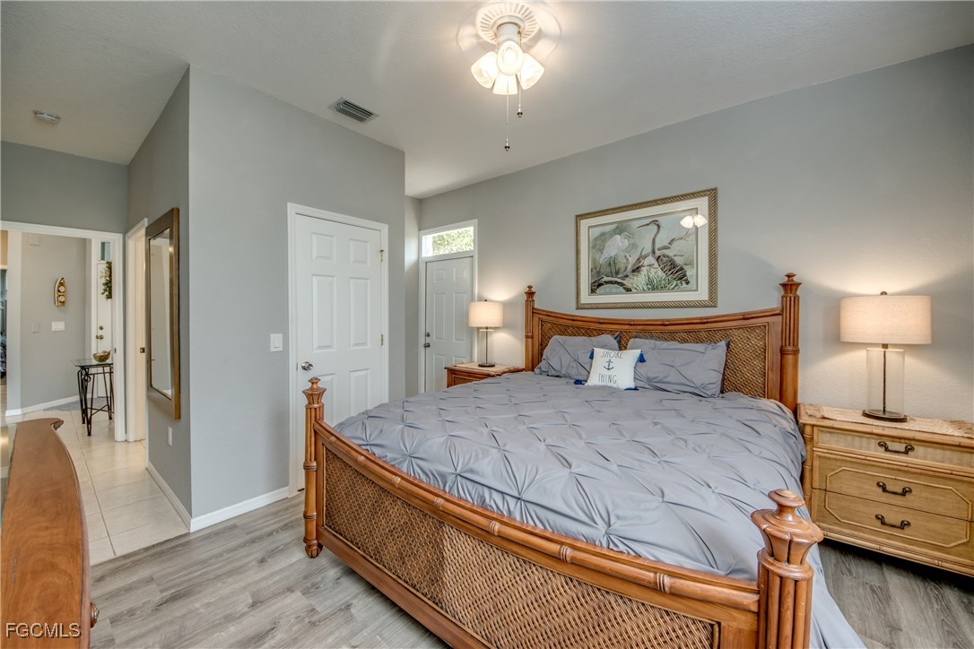 3181 Matecumbe Key Road, Unit 11 Punta Gorda, FL 33955 - Photo 32 of 50 a bedroom with a bed and wooden floor