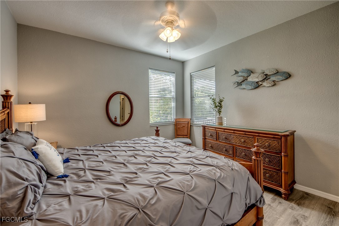 3181 Matecumbe Key Road, Unit 11 Punta Gorda, FL 33955 - Photo 33 of 50 a bedroom with a bed and a chandelier